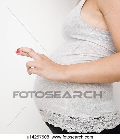 Pregnant woman with fingers crossed View Large Photo Image Stock Photo - Pregnant woman with fingers crossed. Fotosearch