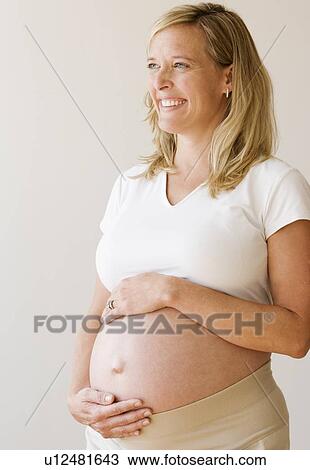 Pregnant woman with hands on belly View Large Photo Image Stock Image - Pregnant woman with hands on belly. Fotosearch