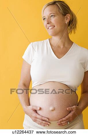 Pregnant woman with hands on belly View Large Photo Image Stock Photo - Pregnant woman with hands on belly. Fotosearch