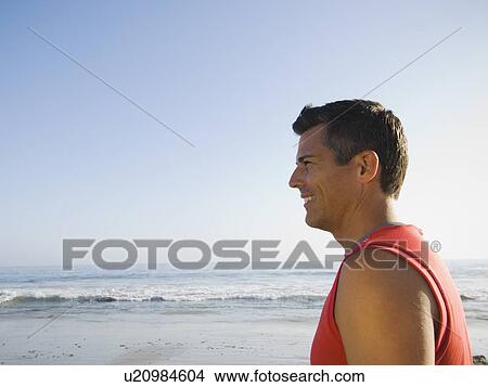 Picture - Profile of man at beach. Fotosearch