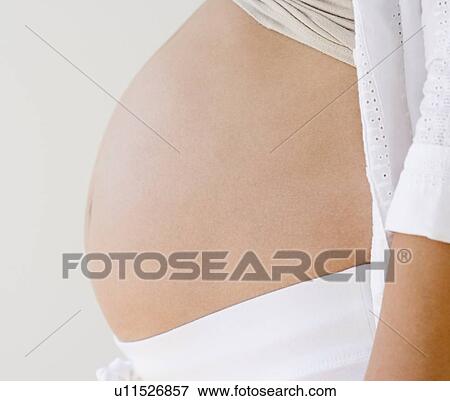 Profile of pregnant woman’s belly View Large Photo Image Stock Photo - Profile of pregnant woman’s belly. Fotosearch