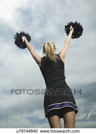 Rear view of cheerleader with pom poms View Large Photo Image Stock Image - Rear view of cheerleader with pom poms. Fotosearch