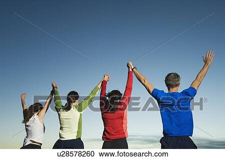Rear view of people with arms raised, Salt Flats, Utah, United States View Large Photo Image Stock Image - Rear view of people with arms raised, Salt Flats, Utah, United States. Fotosearch