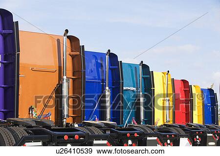 Stock Photo - Rear view of row of tractor trailer cabs. Fotosearch