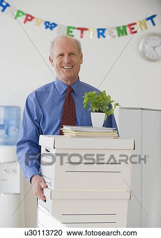 Retiring senior businessman carrying boxes View Large Photo Image Stock Image - Retiring senior businessman carrying boxes . Fotosearch