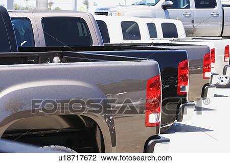 Row of new trucks on lot View Large Photo Image Stock Image - Row of new trucks on lot. Fotosearch