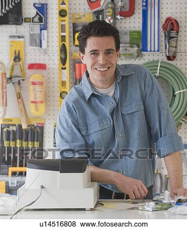 Stock Photo - Sales clerk behind counter at hardware store. Fotosearch