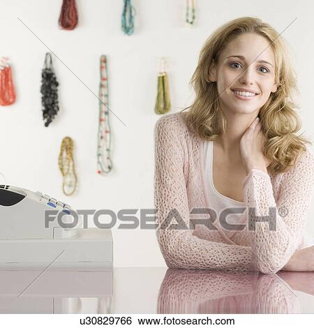 Saleswoman next to register at boutique View Large Photo Image Stock Photograph - Saleswoman next to register at boutique. Fotosearch