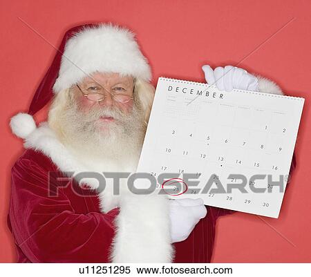 Stock Photography - Santa Claus holding calendar. Fotosearch