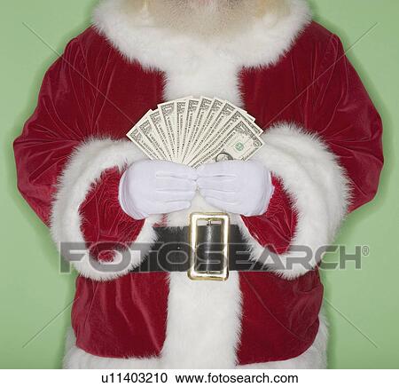 Stock Image - Santa Claus holding fanned out money. Fotosearch