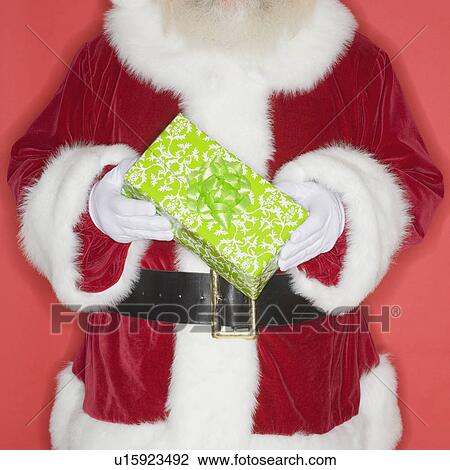 Stock Image - Santa Claus holding gift. Fotosearch