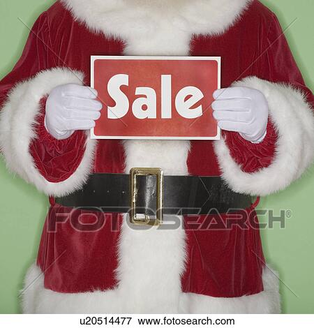 Santa Claus holding Sale sign View Large Photo Image Stock Photo - Santa Claus holding Sale sign. Fotosearch