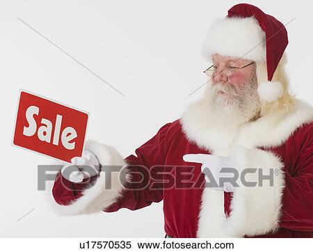 Santa Claus holding Sale sign View Large Photo Image Stock Photography - Santa Claus holding Sale sign. Fotosearch