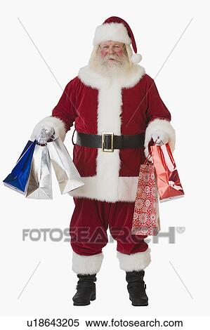 Santa Claus holding shopping bags View Large Photo Image Stock Photography - Santa Claus holding shopping bags. Fotosearch