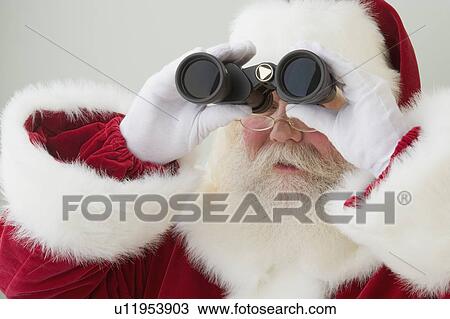 Santa Claus looking through binoculars View Large Photo Image Stock Image - Santa Claus looking through binoculars. Fotosearch