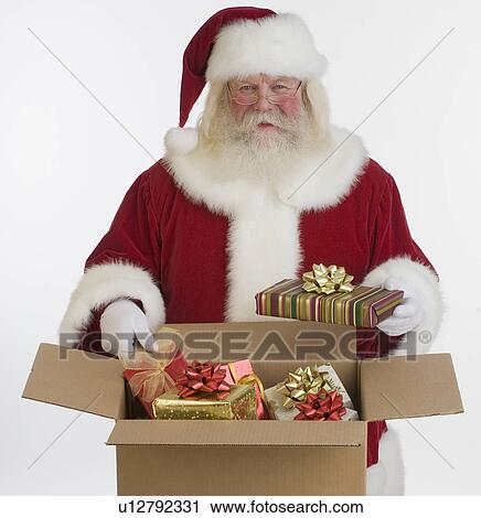 Santa Claus packing gifts in box View Large Photo Image Stock Image - Santa Claus packing gifts in box. Fotosearch