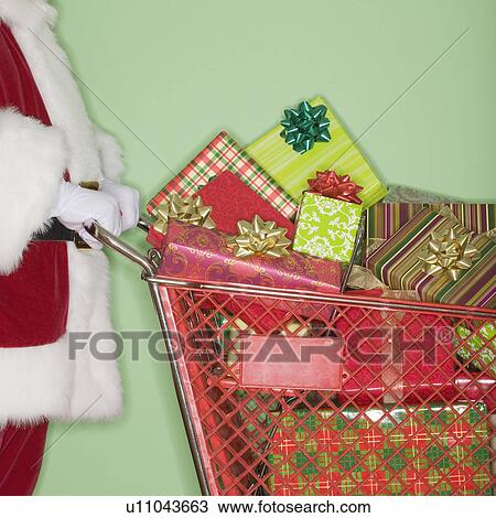 Santa Claus pushing shopping cart of gifts View Large Photo Image Stock Image - Santa Claus pushing shopping cart of gifts. Fotosearch