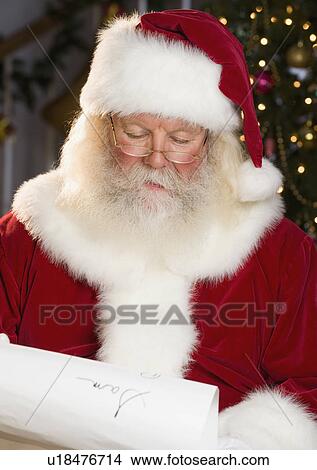Picture - Santa Claus reading list of names. Fotosearch