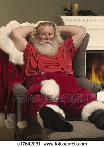 Santa Claus relaxing in armchair View Large Photo Image Stock Image - Santa Claus relaxing in armchair. Fotosearch
