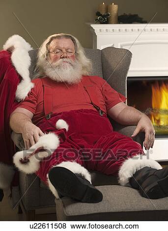 Stock Photo - Santa Claus relaxing in armchair. Fotosearch