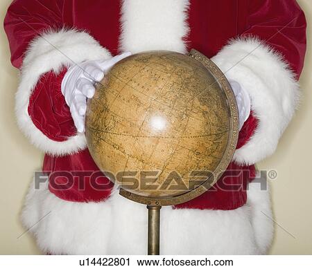Santa Claus with hands on globe View Large Photo Image Stock Image - Santa Claus with hands on globe. Fotosearch
