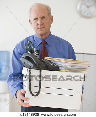 Stock Photography - Senior businessman carrying box of office items. Fotosearch