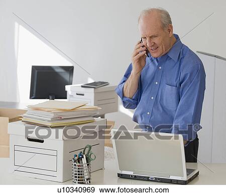 Stock Photo - Senior businessman talking on cell phone. Fotosearch