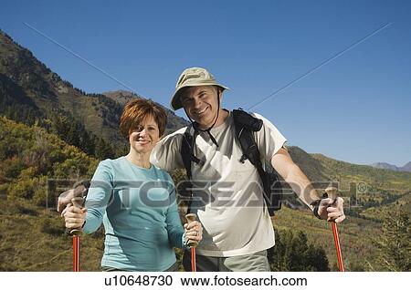 Senior couple holding hiking poles, Utah, United States View Large Photo Image Stock Image - Senior couple holding hiking poles, Utah, United States. Fotosearch