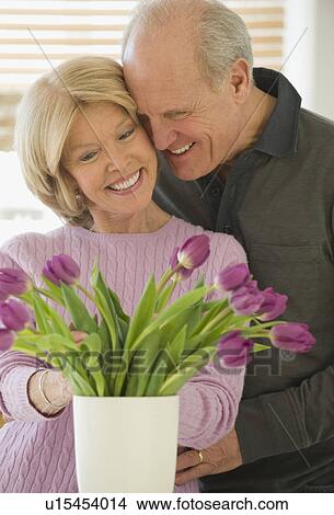 Senior couple looking at flowers View Large Photo Image Picture - Senior couple looking at flowers. Fotosearch