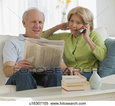 Stock Photography - Senior couple relaxing on sofa. Fotosearch