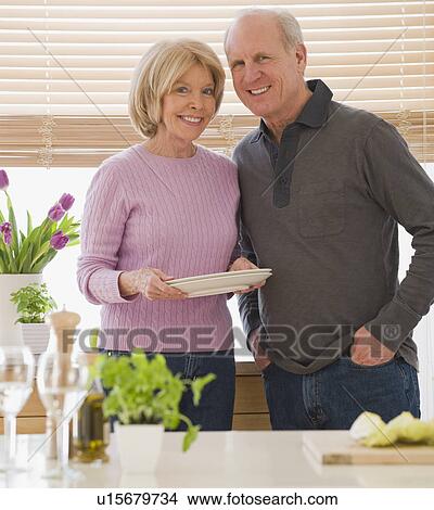 Senior couple with dishes in kitchen View Large Photo Image Picture - Senior couple with dishes in kitchen. Fotosearch