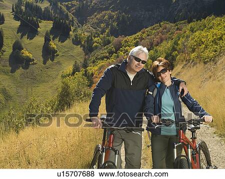 Stock Photo - Senior couple with mountain bikes, Utah, United States. Fotosearch