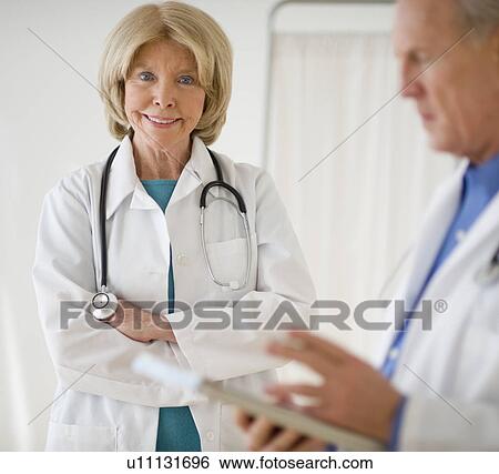 Senior female doctor with arms crossed View Large Photo Image Stock Photograph - Senior female doctor with arms crossed. Fotosearch