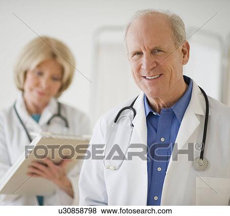 Stock Photo - Senior male doctor with stethoscope around neck. Fotosearch