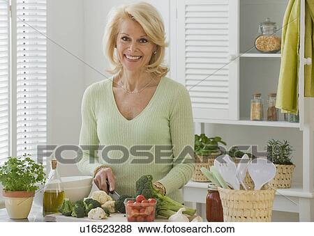 Senior woman chopping vegetables View Large Photo Image Stock Photo - Senior woman chopping vegetables. Fotosearch