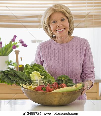 Senior woman holding bowl of vegetables View Large Photo Image Stock Photography - Senior woman holding bowl of vegetables. Fotosearch
