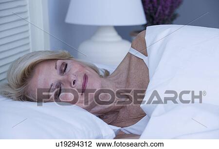 Senior woman sleeping in bed View Large Photo Image Stock Image - Senior woman sleeping in bed. Fotosearch