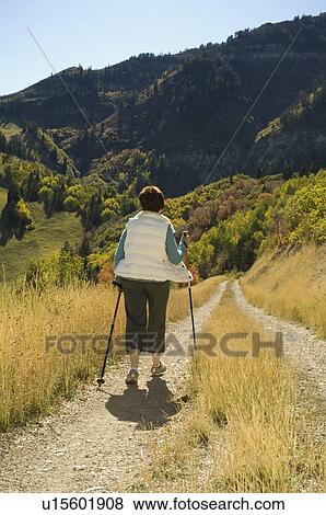 Senior woman walking with hiking poles, Utah, United States View Large Photo Image Stock Photo - Senior woman walking with hiking poles, Utah, United States. Fotosearch