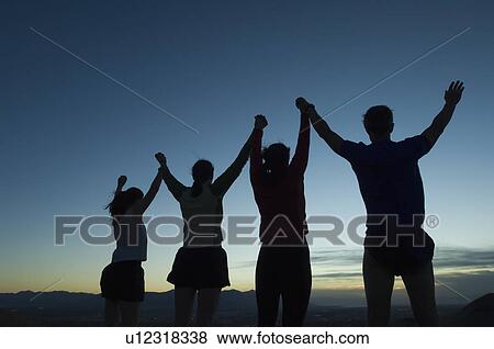Silhouette of people with arms raised, Salt Flats, Utah, United States View Large Photo Image Stock Photo - Silhouette of people with arms raised, Salt Flats, Utah, United States. Fotosearch