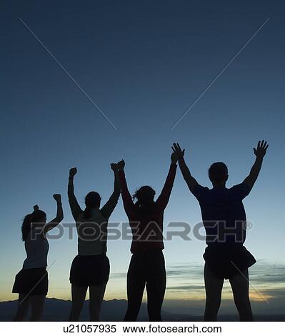 Silhouette of people with arms raised, Salt Flats, Utah, United States View Large Photo Image Stock Photography - Silhouette of people with arms raised, Salt Flats, Utah, United States. Fotosearch