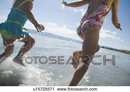 Sisters running in water, Utah, United States View Large Photo Image Stock Image - Sisters running in water, Utah, United States. Fotosearch