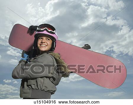Stock Photograph - Snowboarder holding board on shoulder. Fotosearch