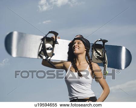 Stock Photography - Snowboarder holding board on shoulder. Fotosearch