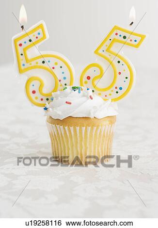 Stock Photograph - Special cupcake with candles for 55. Fotosearch