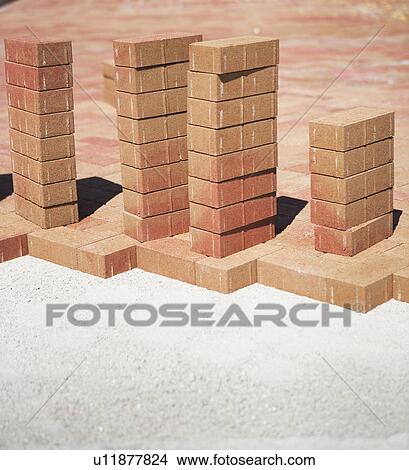 Picture - Stacks of bricks on edge of new patio. Fotosearch