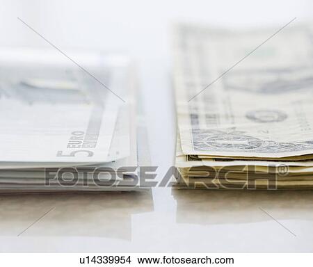 Picture - Stacks of Euros and American dollars. Fotosearch