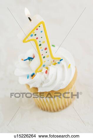 Still life of cupcake with one candle View Large Photo Image Picture - Still life of cupcake with one candle. Fotosearch