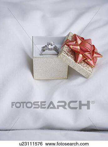 Still life of diamond ring on pillow View Large Photo Image Stock Photograph - Still life of diamond ring on pillow. Fotosearch