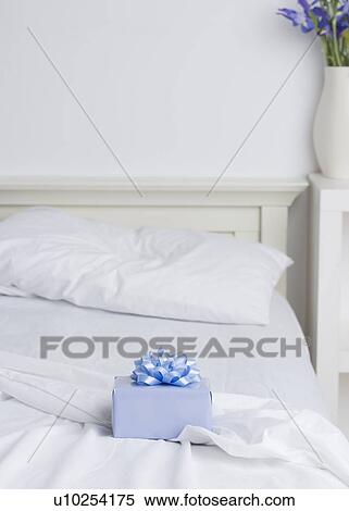 Still life of gift box on bed View Large Photo Image Stock Photography - Still life of gift box on bed. Fotosearch