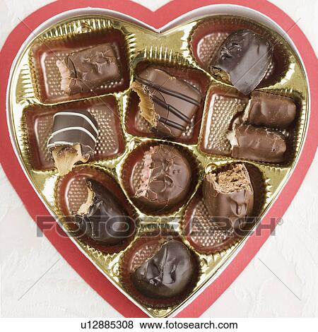 Stock Photo - Still life of heart shaped box of chocolates. Fotosearch